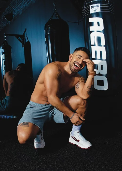 Male fitness model posing in a gym